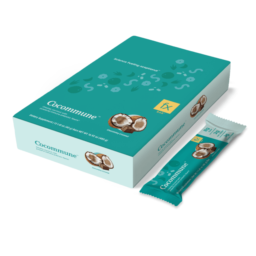 A box of chocolate covered peanuts on top of a green background.