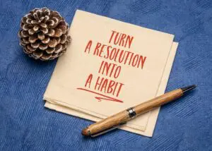turn a resolution into a habit inspirational advice or reminder on a napkin, New Year resolutions, setting goals and personal development concept