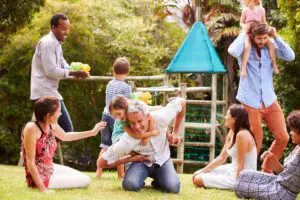 Adults and kids having fun playing in the backyard.