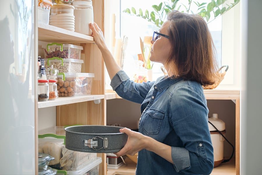 woman cleaning pantry