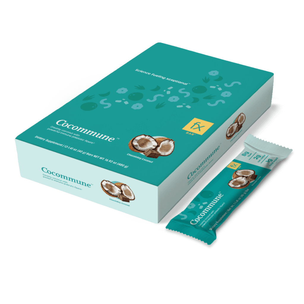 A box of chocolate covered peanuts on top of a green background.