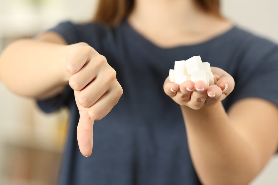 woman-holding-sugar-thumbs-down