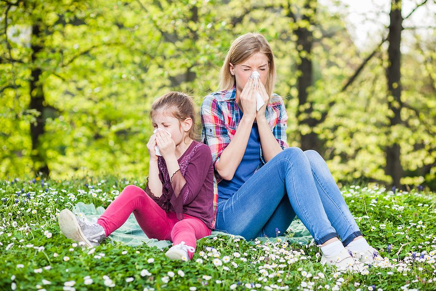 mother daughter outside sneezing