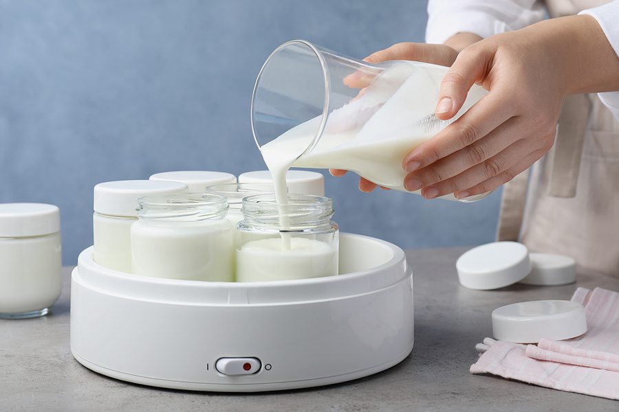 woman making yogurt in yogurt machine