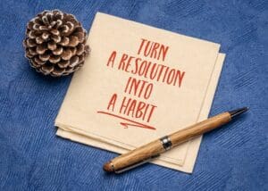 turn a resolution into a habit inspirational advice or reminder on a napkin, New Year resolutions, setting goals and personal development concept