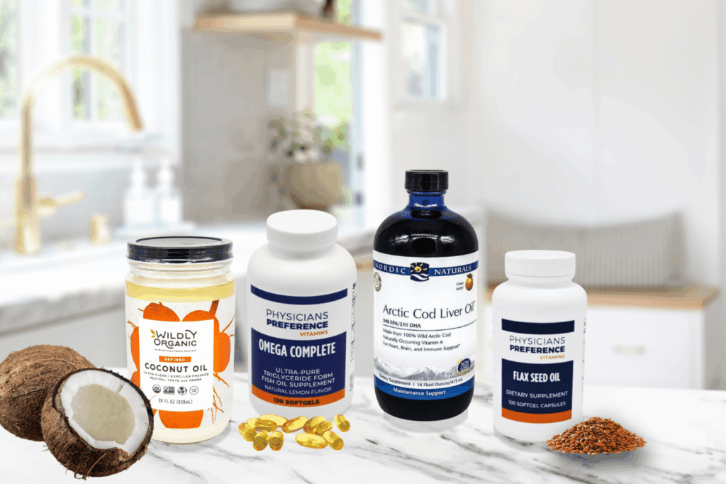 A kitchen counter with supplemental oils: Coconut Oil, Omega Complete, Artic Cod Liver Oil, and Flax Seed Oil.