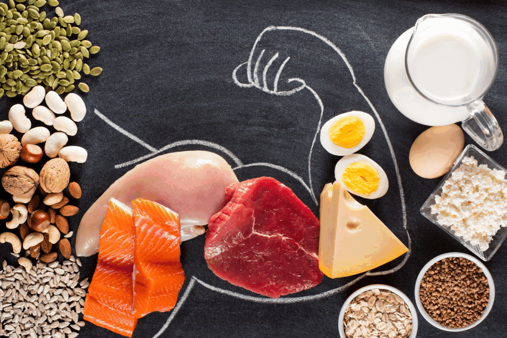 Chalk outline of a muscular arm with protein-rich food in the outline.