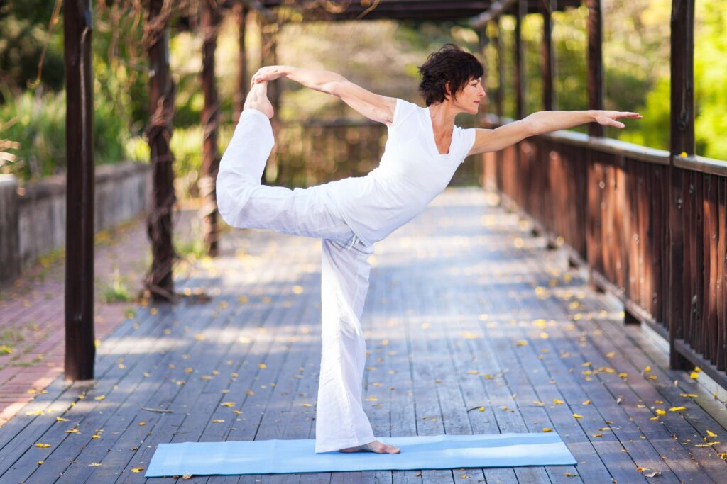 Middle-aged woman doing yoga for anti-aging supplements and longevity