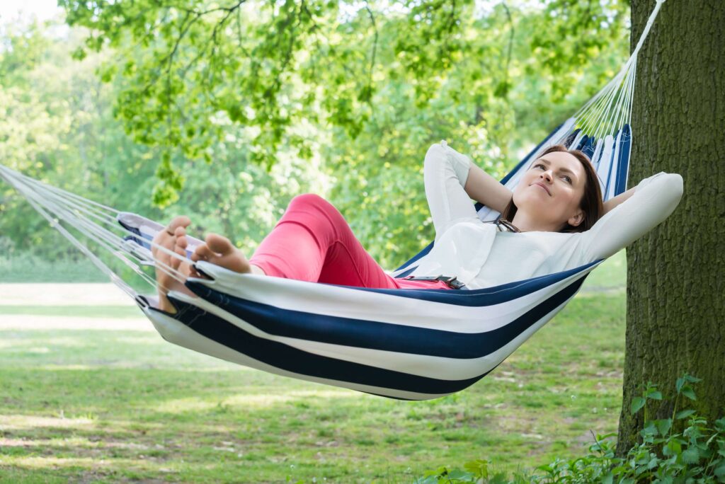 Woman relaxing in hammock pondering how stress nutrient depletion affects energy, mood, sleep, and nervous system balance.
