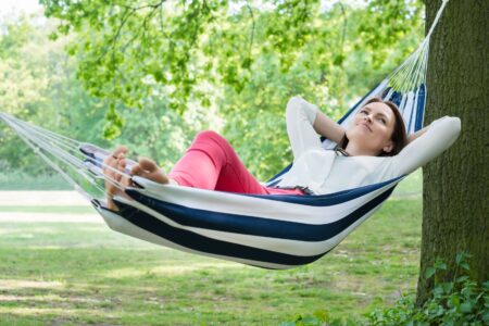 Woman relaxing in hammock pondering how stress nutrient depletion affects energy, mood, sleep, and nervous system balance.