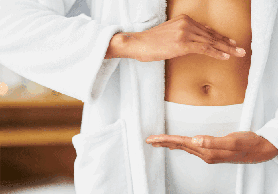 Blog Website Picture Woman in a robe framing her belly to signify gut health.