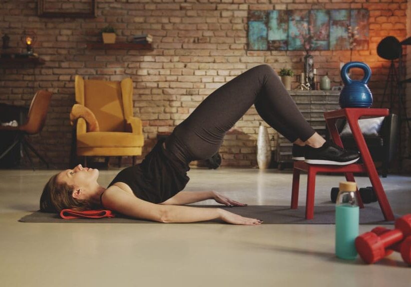 Fitness training at home. Young woman doing abdomen workout, exe Fitness training at home. Young woman doing abdomen workout, exercising in living room. Stay at home and stay fit and healthy.