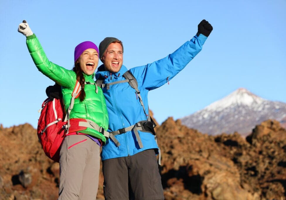 Couple in winter celebrating because they climbed a mountain using the energy from Energy Formula.