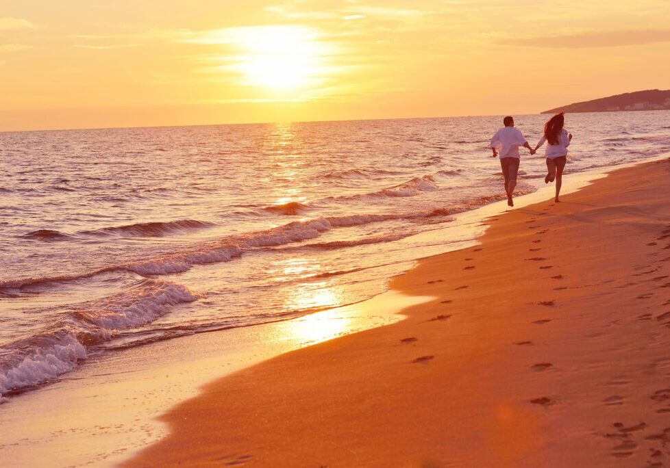 happy young romantic couple in love have fun on beautiful beach happy young romantic couple in love have fun on beautiful beach at beautiful summer day